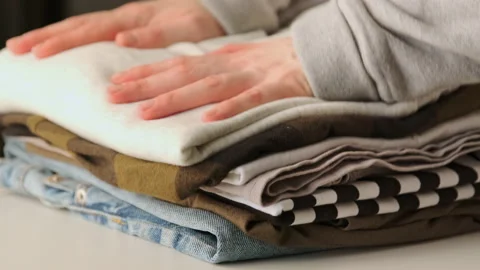 Stack clothing for sorting and baggage packing. Clothes for donation Stock Footage 168762726