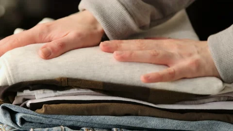 Stack clothing for sorting and baggage packing. Clothes for donation Stock Footage 168762797