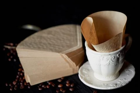 A stack of coffee filters from Kraft paper, and white Cup .Macro 스톡 사진