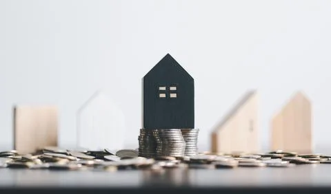 Stack coin on and home model for family put on top in office, Business inve.. Stock Photos