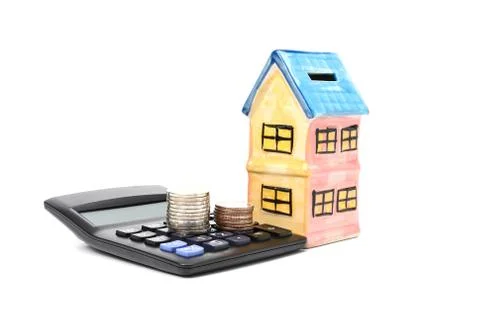 The stack of coin calculator with model home ceramic with coin concept Saving Photos