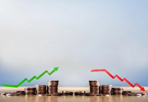 Stack coins and arrow red green graph chart volatility up and down on wooden Stock Photos