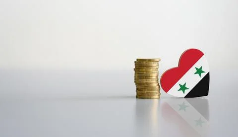 A stack of coins and the flag of Syria in the shape of a heart. Stock Photos