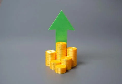 Stack of coins and green arrow pointing up. Financial growth, income increase Stock Photos