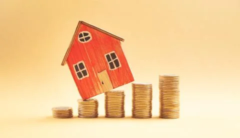 Stack of coins and house model. Saving money for buy a house Stock Photos