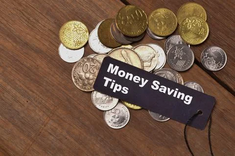 Stack of coins and memo note written with MONEY SAVING TIPS. Financial concep Stock Photos