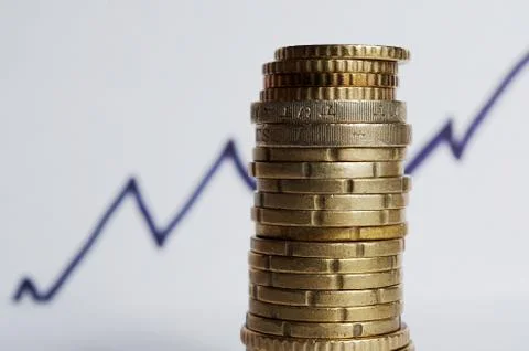 Stack of coins and rising line behind Stock Photos