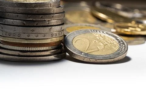 Stack of the coins and Two euro coin with soft focus Stock Photos