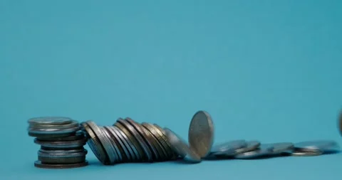 A stack of coins on a blue background Stock Footage 140235542