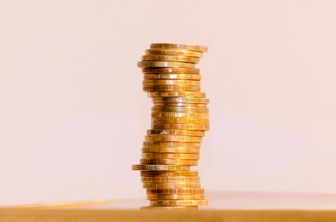 Stack of coins close-up on a gold background Stock Photos