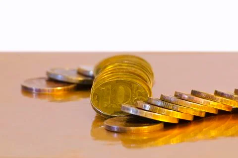 Stack of coins close-up on a gold background Stock Photos