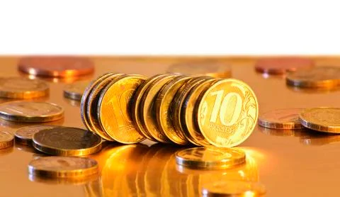 Stack of coins close-up on a gold background Foto stock