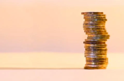 Stack of coins close-up on a gold background Stock Photos