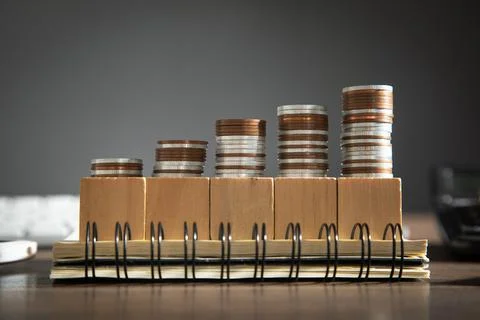 Stack of coins with a cubes the table. Business. Finance Stock Photos