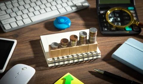 Stack of coins with a cubes the table. Business. Finance Stockfoto's