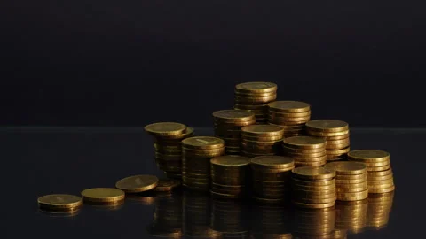 Stack Of Coins With Golden Light Stock Footage 241709114