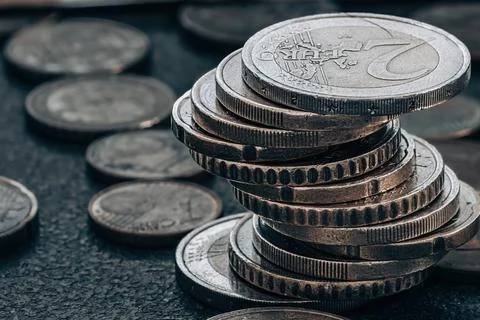 Stack of coins on grey textured background Fotos Stock