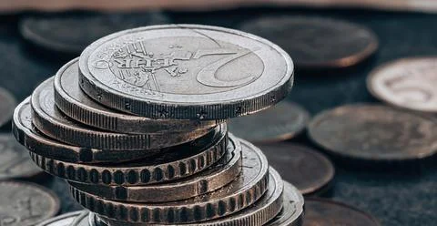 Stack of coins on grey textured background Foto stock