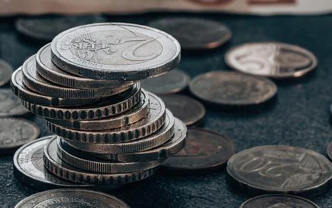 Stack of coins on grey textured background 库存照片