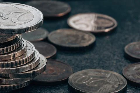 Stack of coins on grey textured background 库存照片