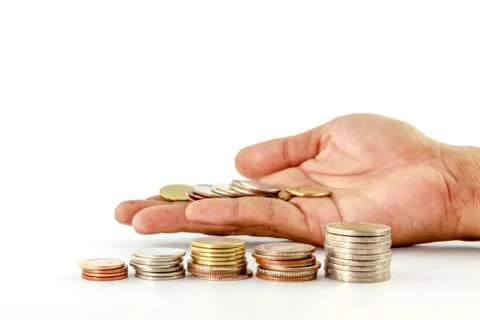 Stack of coins in hand Stock Photos