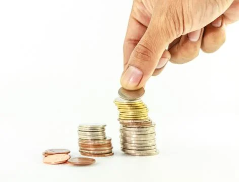 Stack of coins with hand on Stock Photos