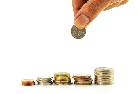 Stack of coins with hand ,thai bath Stock Photos