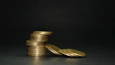 Stack of coins isolated on dark background Foto stock