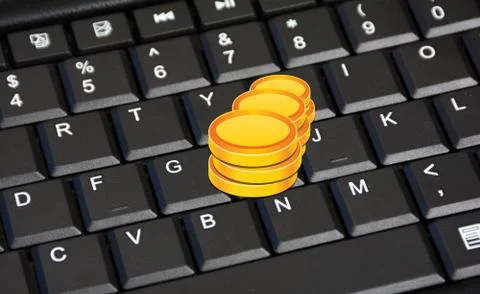 Stack of Coins on Keyboard closeup earning concept Foto stock
