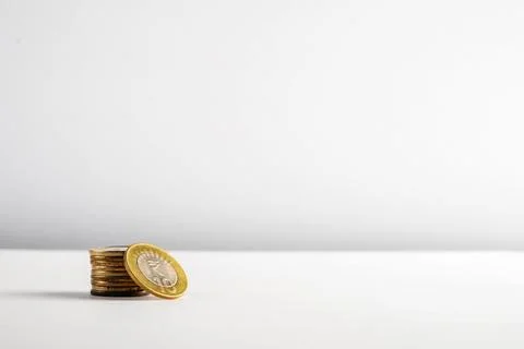 Stack of Coins on a Minimalistic White Background Stock Photos