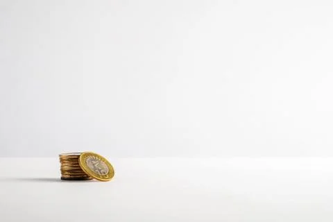 Stack of Coins on a Minimalistic White Background Stock Photos