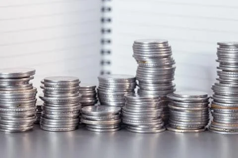 Stack of Coins on Note Background Stock Photos