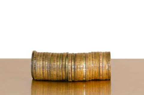 A stack of coins, placed horizontally on a white background Stock Photos