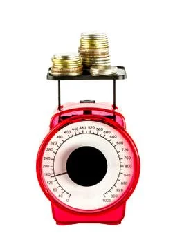 Stack of coins on scale Stock Photos