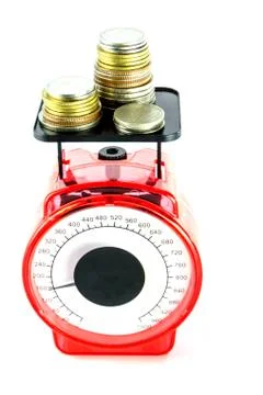 Stack of coins on scale Stock Photos