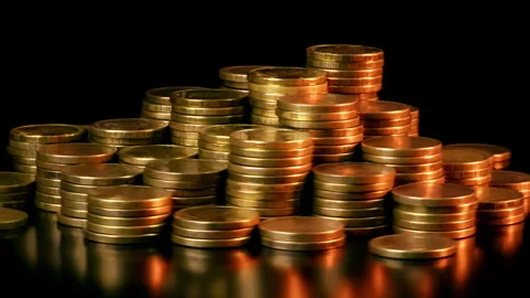 A Stack Of Coins Is Spinning In A Golden Light Stock Footage 265133696