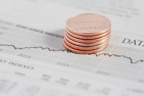 Stack of coins on stock market data Stockfoto's