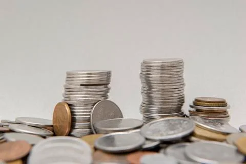 Stack of coins with white background. Selective focus. Stock Photos