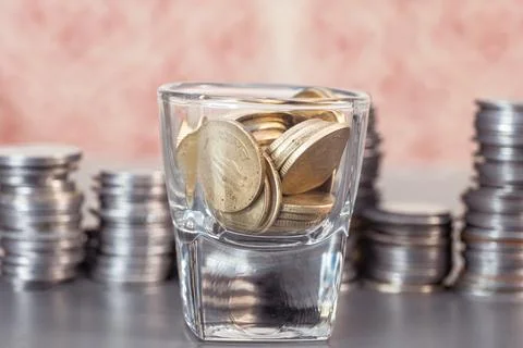 Stack of Coins in Wine Glass Stock Photos