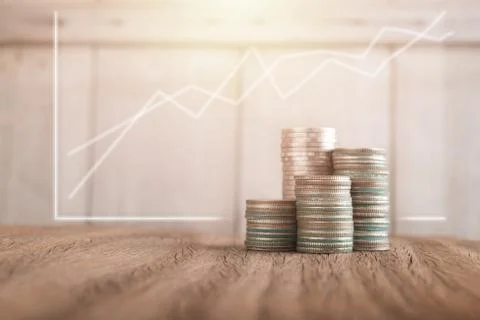 Stack of coins on wood background Stock Photos