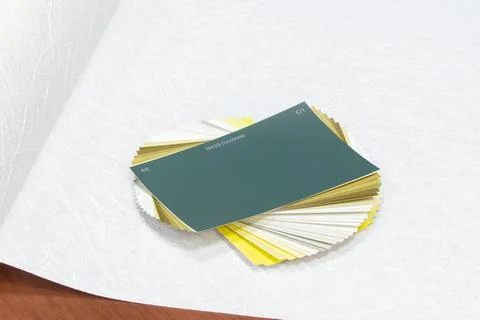 Stack of color swatches with their names on wallpaper for painting, selective Stock Photos