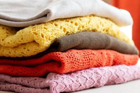 Stack of colored and textured sweaters Stock Photos