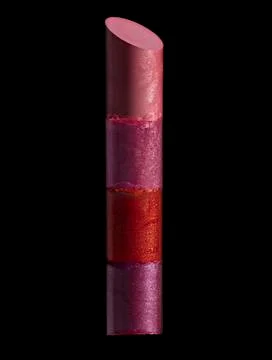 Stack of colored broken lipsticks on black Stock Photos
