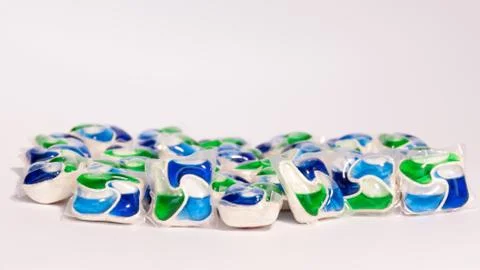 A stack of colored concentrated capsules in the dishwasher Foto stock