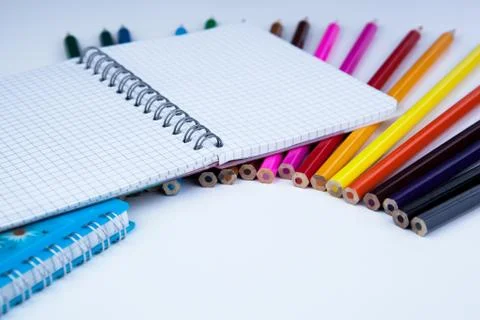 A stack of colored pencils with notebook Stock Photos