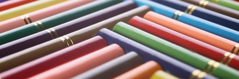 Stack of colored pencils placed in creative order with golden design on it Stock Photos