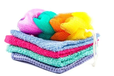 Stack of colored towels and bath sponge. Stock Photos