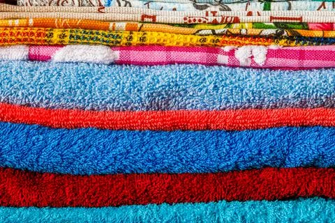 Stack of colored towels full frame close-up background Stock Photos