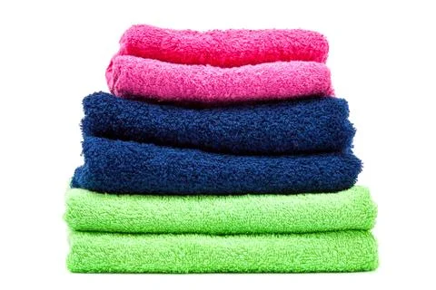Stack of colored towels on white background. Stock Photos