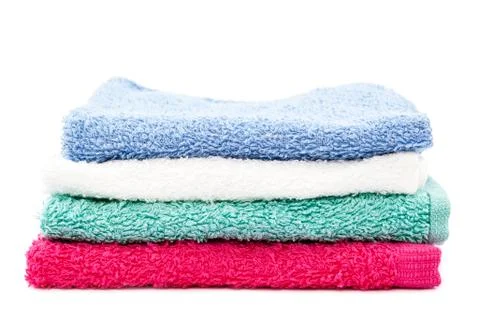 Stack of colored towels on white background. Stock Photos